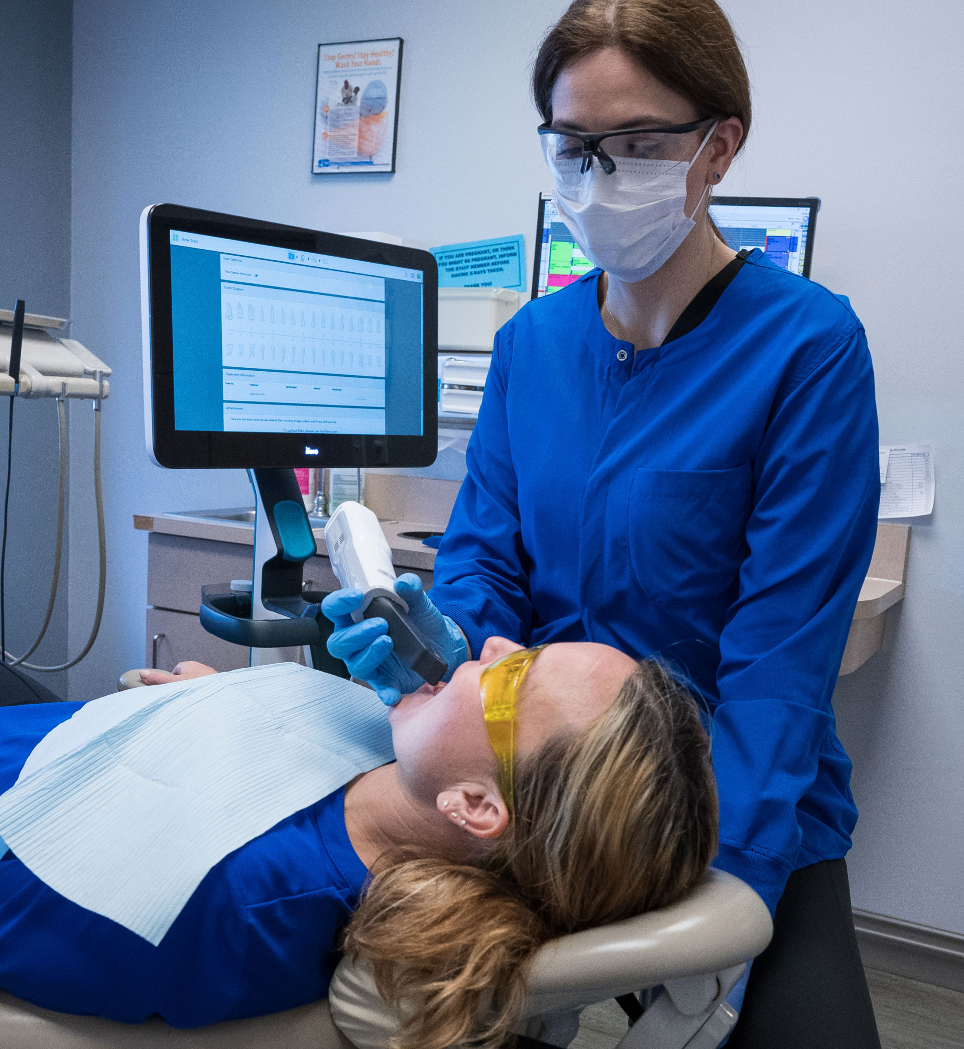 assistant using iTero scanner on patient in dental chair